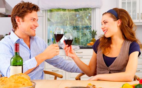 الزوج والزوجة تناول العشاء مع أكواب من النبيذ