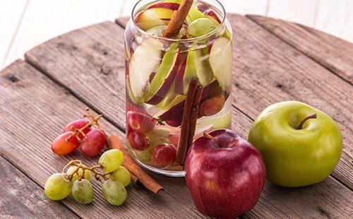 Äpfel und Trauben auf einem Holztisch