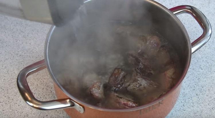 Ezután helyezze a húst a serpenyőbe, és öntsen forrásban lévő vizet.