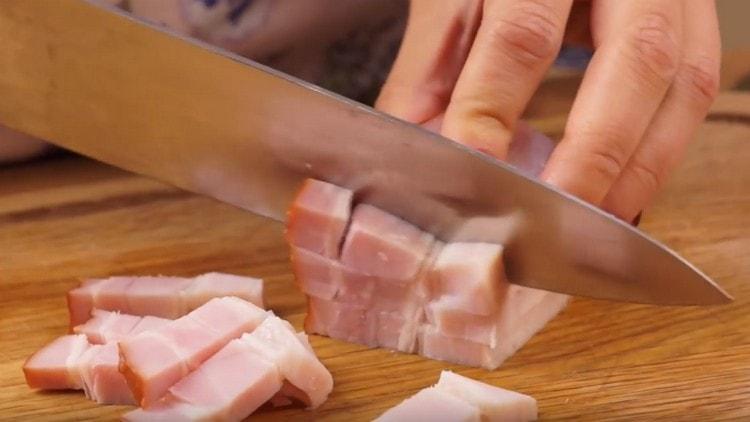 Tagliare la lombata di maiale affumicata in piccoli pezzi.