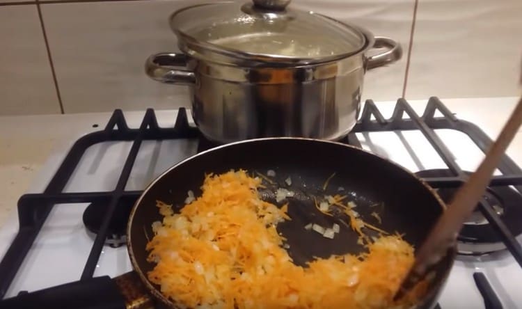 Προσθέστε τριμμένα καρότα στο κρεμμύδι στο τηγάνι.