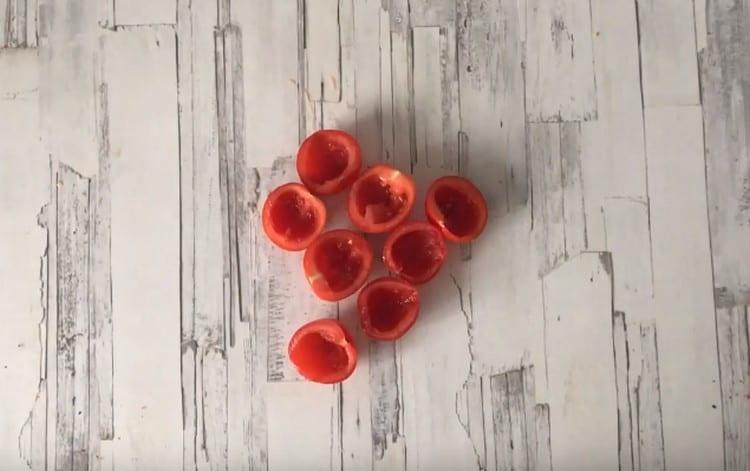 Nakrájejte cherry rajčata na polovinu a vyjměte buničinu lžičkou.