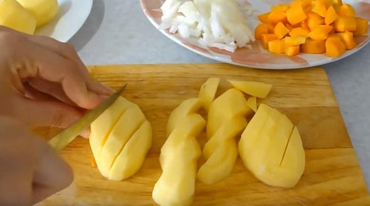 تقطيع البطاطا إلى قطع.