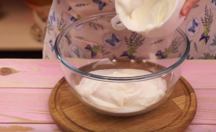 Per preparare la crema, unire la panna acida allo zucchero.