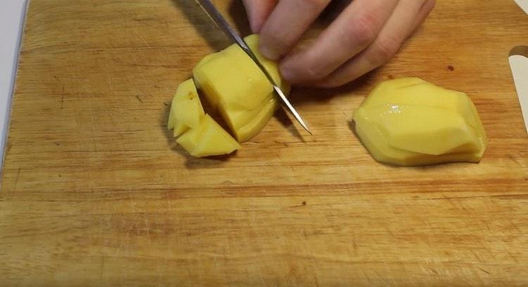 Ξεφλουδίστε και ψιλοκόψτε τις πατάτες σε μικρά κομμάτια.