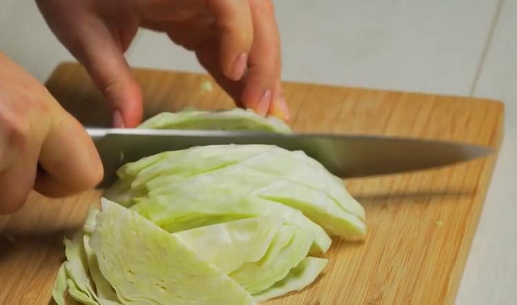 Um einen Gemüseeintopf mit Fleisch zuzubereiten, den Kohl hacken