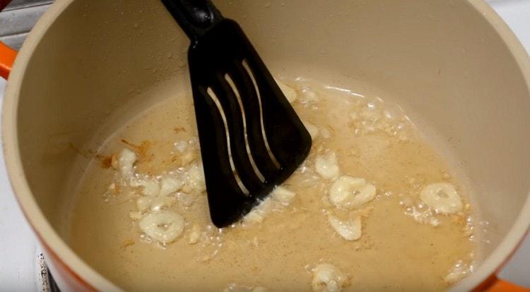 Διαδώστε ψιλοκομμένο σκόρδο στο λάδι που προκύπτει.