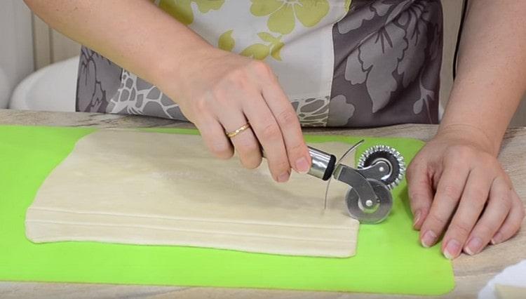 Разточете бутер тестото тънко и нарежете на тънки ивици.