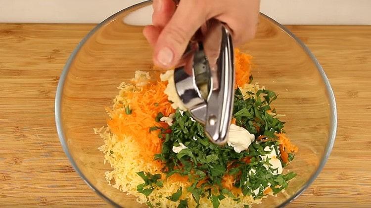 Cottura del ripieno di carote e formaggio grattugiati. erbe tritate, aglio e maionese.