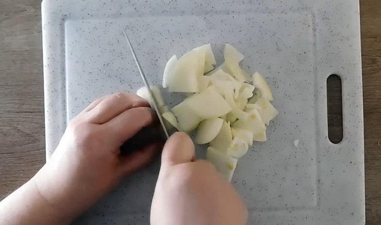 يقطع البصل إلى حلقات ربع.