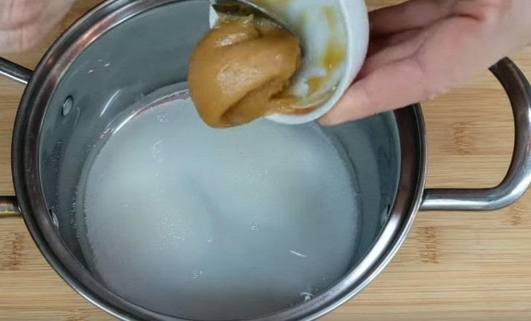Изсипете вода в тенджера, добавете захар и мед.