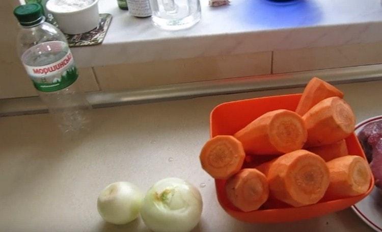 Sbucciate e tritate le cipolle e le carote.