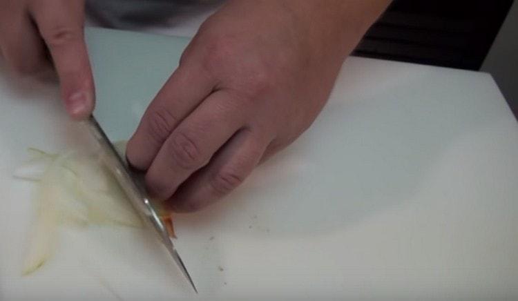 Leikkaa sipulit ohuiksi puolirenkaiksi.