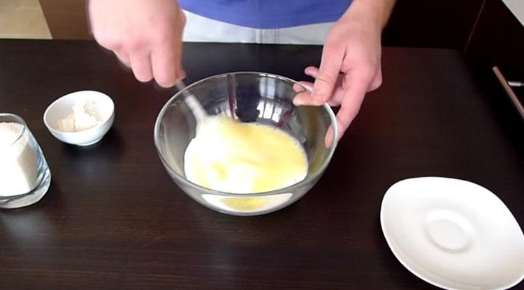 Комбинирайте заквасената сметана с яйцето, разбъркайте.