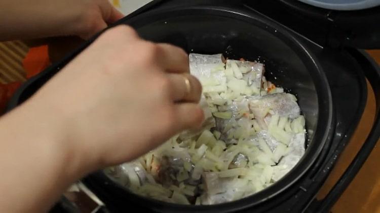 Legen Sie die Zwiebeln auf den Fisch, um Pollock in einem langsamen Kocher zu kochen