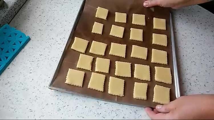 За да приготвите юбилейните бисквитки, поставете тестото върху лист за печене