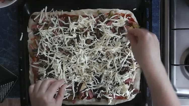Įdėkite sūrį ant grybų, kad gautumėte picą su marinuotais agurkais