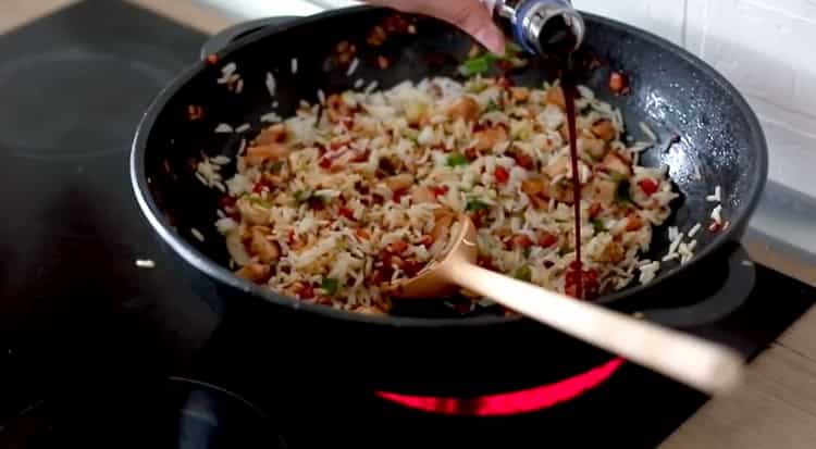 Adjon hozzá szójaszószt, hogy főzzük rizst zöldséggel és csirkével