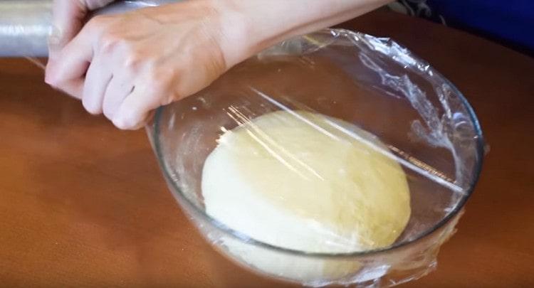 Покрийте тестото в купа със залепващ филм и изчакайте да пасне.