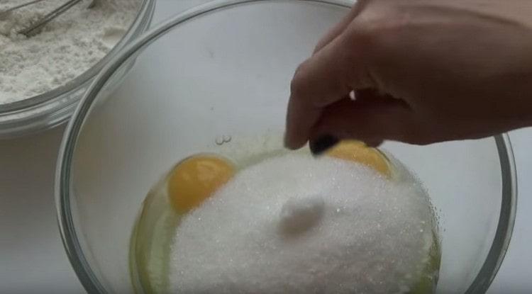 Добавете сол и захар към яйцата.