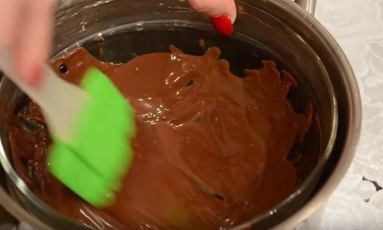 Λιώνουμε τη σοκολάτα σε ένα λουτρό νερού.