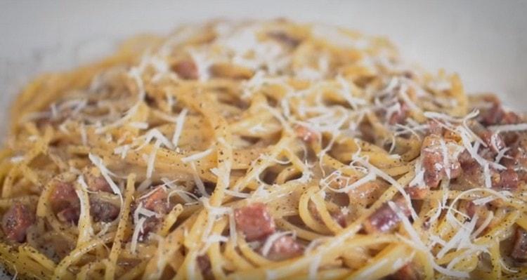 Wenn Sie Spaghetti mit Speck servieren, können Sie Parmesan darüber streuen.