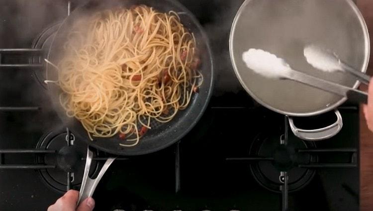 Į keptuvę įpilkite spagečių, iš jo išėmę česnaką.