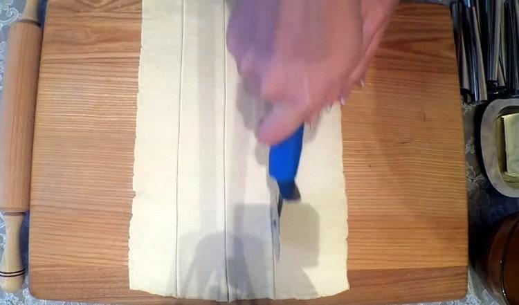 Stendi la pasta sfoglia in un rettangolo e tagliala a strisce.