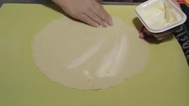 За да направите плоски питки на вода, намажете тестото с масло