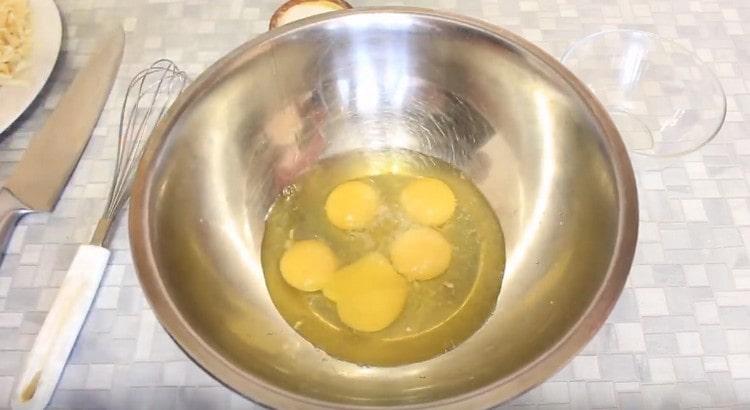 Разбиваме яйцата в купа, добавяме сол, черен пипер.