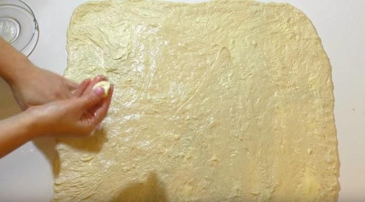 Výslednou vrstvu těsta namažte máslem.