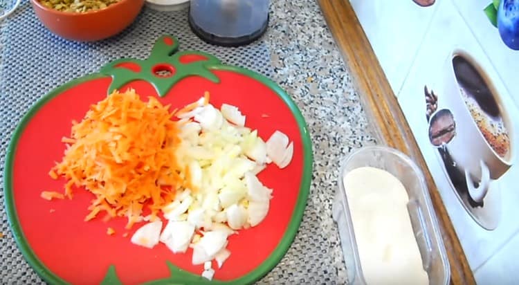 Τρίψτε τα κρεμμύδια και τα καρότα.
