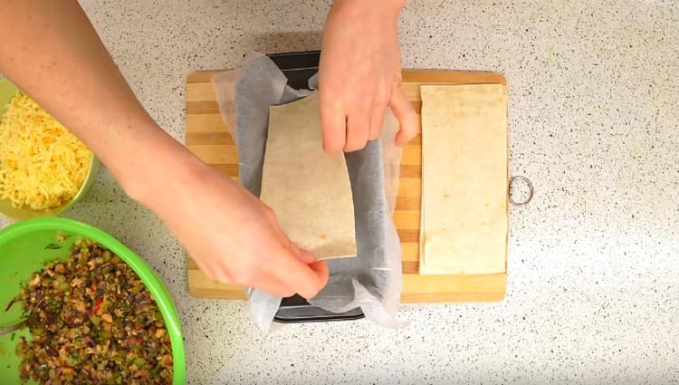 В долната част на формата разстиламе първия лист с пита питка.