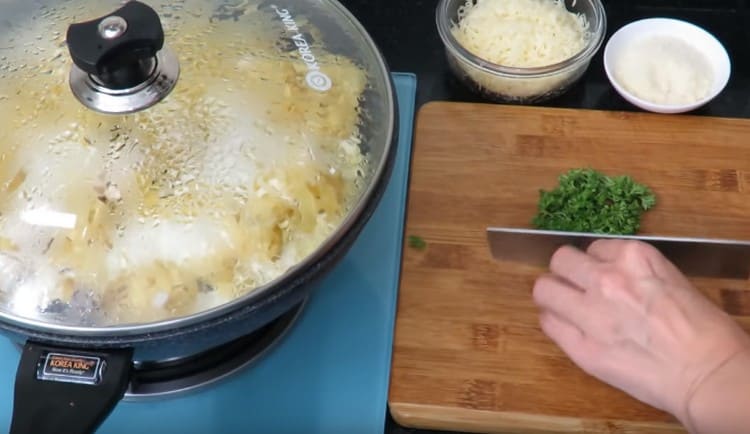 Während die Pasta gekocht wird, hacken Sie frische Kräuter.