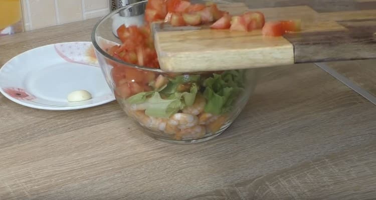 Die Tomaten in Würfel schneiden und in einer Schüssel auf die restlichen Produkte verteilen.