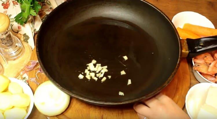 Friggere l'aglio in una padella.
