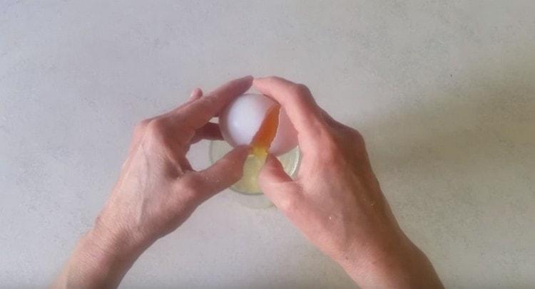 Σπάστε ένα αυγό σε ένα ποτήρι.