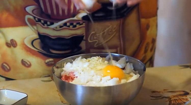 įmušti kiaušinį į maltą mėsą, įberti druskos ir pipirų.