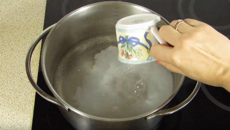 Доведете водата до кипене в тенджера, добавете сол.