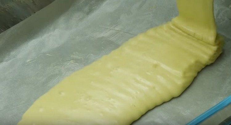 Изсипете половината тесто във формата и сложете във фурната.