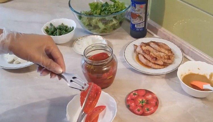supjaustykite džiovintus pomidorus žirklėmis.
