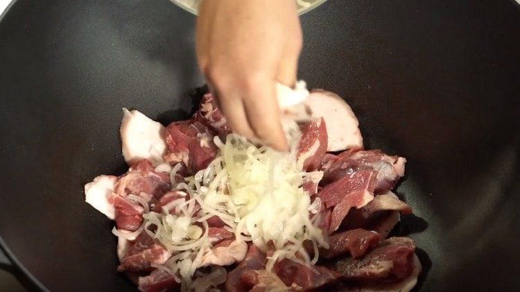 ضع البصل فوق اللحم.