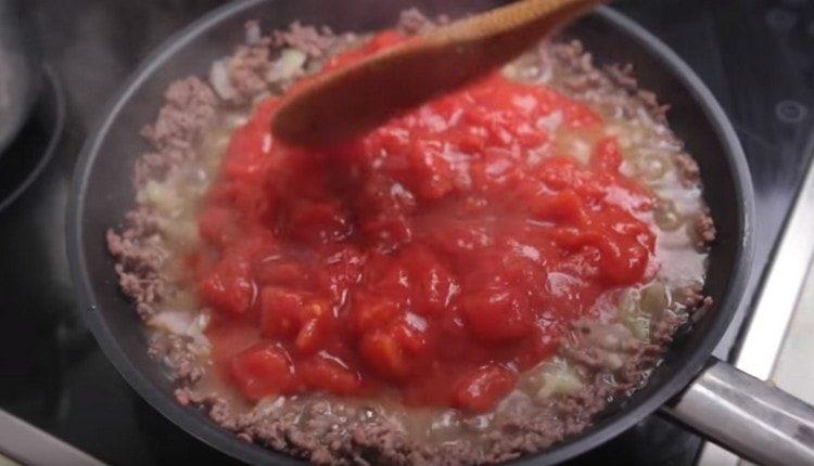 Mes perkeliame daržoves į maltą mėsą, įpilkite pomidorų į savo sultis.
