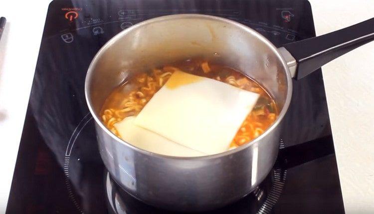 Přidejte plátky zpracovaného sýra.