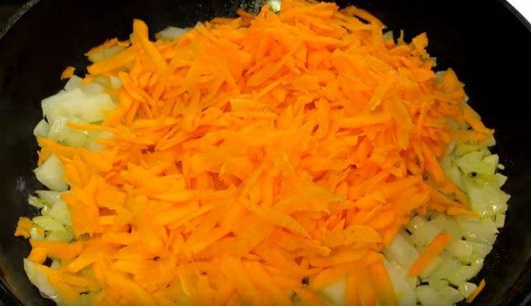 Zwiebeln und Karotten in einer Pfanne verteilen.