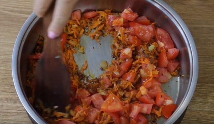 Към тигана добавете и нарязания домат.