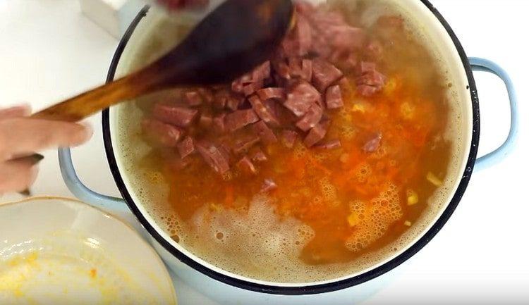 Разстиламе наденица в тенджера със супа.